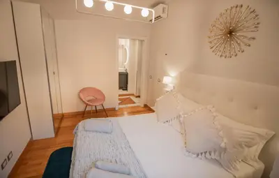 a bedroom with a bed with white sheets and pillows at Bruno Domus Design in Rome