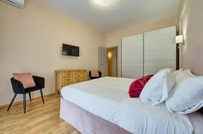 a bedroom with a large bed and a chair at Vatican Pop House in Rome