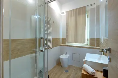 a bathroom with a shower and a sink and a toilet at Vatican Pop House in Rome