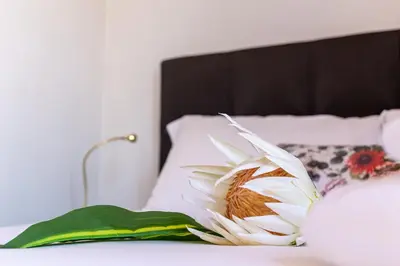 a flower sitting on top of a bed at iFlat Campo de' Fiori Panoramic Penthouse in Rome