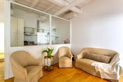 a living room with two chairs and a table at iFlat Spanish Steps Peaceful Apartment in Rome