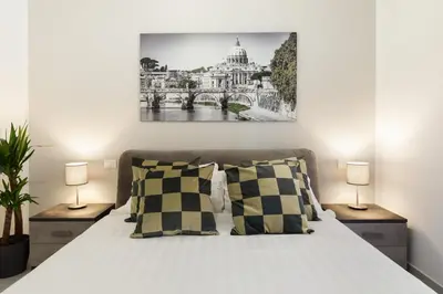 a bedroom with a large bed with two lamps at Clodio Welcome - 5 camere arredate con bagno interno - zona comune - condizionatori - in Rome