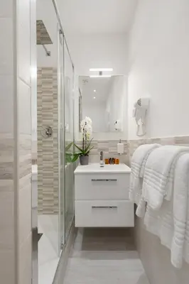 a white bathroom with a sink and a shower at Clodio Welcome - 5 camere arredate con bagno interno - zona comune - condizionatori - in Rome