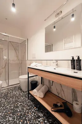 a bathroom with a sink and a toilet and a shower at NAMAN HOTELLERIE - Monti in Rome