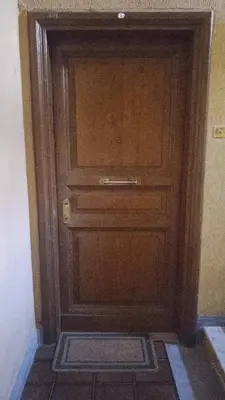 a wooden door in a room with a tile floor at Testaccio Bodoni apartment in Rome