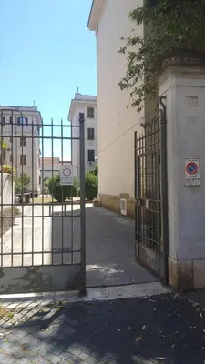 an open gate to a building with a building at Testaccio Bodoni apartment in Rome