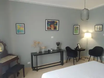 a bedroom with two chairs and a table and a bed at Testaccio Bodoni apartment in Rome