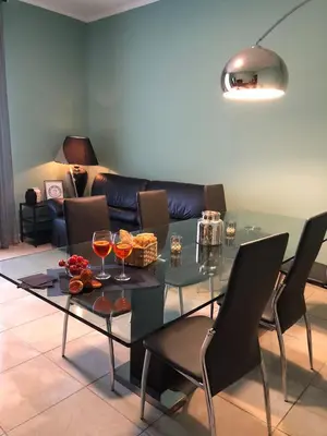 a living room with a glass table and a couch at Testaccio Bodoni apartment in Rome
