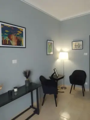 a waiting room with two chairs and a table and a lamp at Testaccio Bodoni apartment in Rome