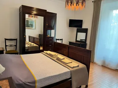 a bedroom with a bed and a large mirror at Holiday Garden House Roma in Rome