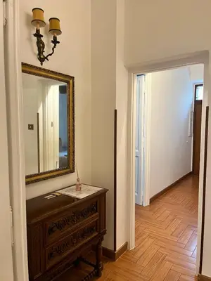 a room with a mirror and a dresser and a hallway at Holiday Garden House Roma in Rome