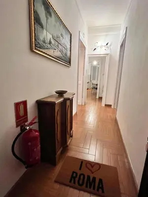 a room with a painting on the wall and a door at Holiday Garden House Roma in Rome