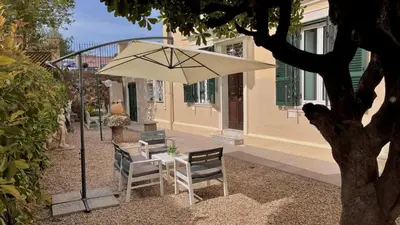 a tree and a bench in a garden at Holiday Garden House Roma in Rome