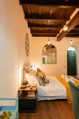 a bedroom with a bed and a table at Studio Campo de' Fiori in Rome