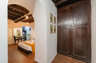 a bedroom with a large wooden door and a bed at Studio Campo de' Fiori in Rome