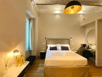 a bedroom with a large bed and a large window at Queen of Rome Luxury Rooms in Rome