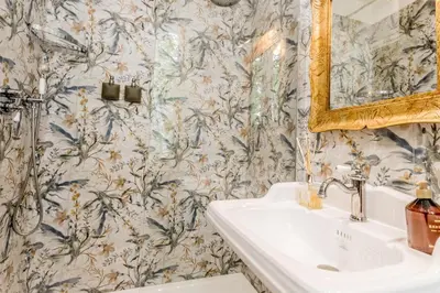 a bathroom with a sink and a mirror at Queen of Rome Luxury Rooms in Rome