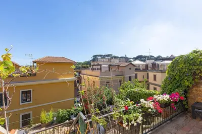 a view of a city from a balcony with flowers at Appartamento Vatican Terrace in Rome