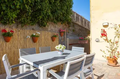 a white table and chairs on a patio with flowers at Appartamento Vatican Terrace in Rome