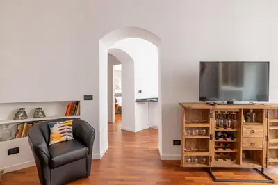 a living room with a chair and a television at Cavour 211 - B&D Apartments in Rome