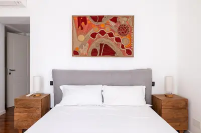 a bedroom with a bed and a painting on the wall at Cavour 211 - B&D Apartments in Rome
