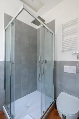 a shower stall in a bathroom with a toilet at Cavour 211 - B&D Apartments in Rome