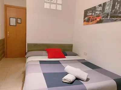 a bed in a room with two towels on it at Overseas Guesthouse in Rome