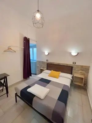 a bedroom with a bed and a table in it at Overseas Guesthouse in Rome