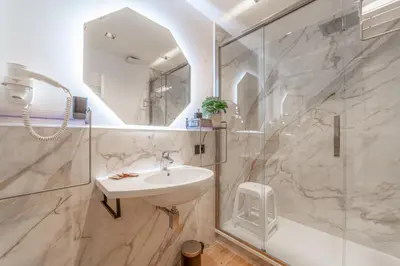 a bathroom with a sink and a shower at Luxury Vatican Rooms - next to the Vatican Museum in Rome