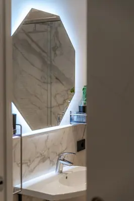 a bathroom with a sink and a mirror at Luxury Vatican Rooms - next to the Vatican Museum in Rome