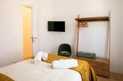 a bedroom with a bed and a tv on the wall at LV Vatican boutique apartment in Rome