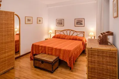 a bedroom with a bed with an orange bedspread at Navona Romantic House in Rome