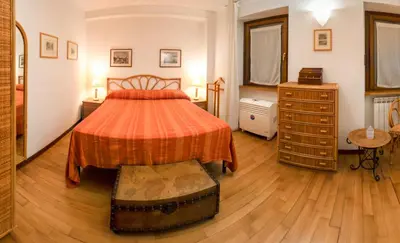 a bedroom with a bed and a dresser in it at Navona Romantic House in Rome