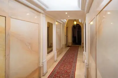 a hallway with white columns and a red carpet at Navona Romantic House in Rome