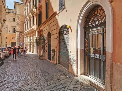 a cobblestone street with people walking down the street at Navona Romantic House in Rome