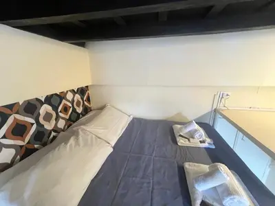 a small bed in a small room with a table at Casa Lella al Borgo Pio, a pochi passi da San Pietro in Rome