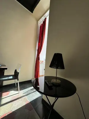 a room with a table and a chair and a window at Casa Lella al Borgo Pio, a pochi passi da San Pietro in Rome