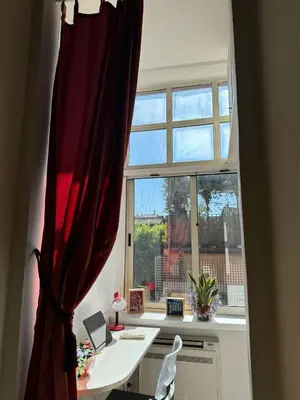 a window with a desk in front of a window at Casa Lella al Borgo Pio, a pochi passi da San Pietro in Rome