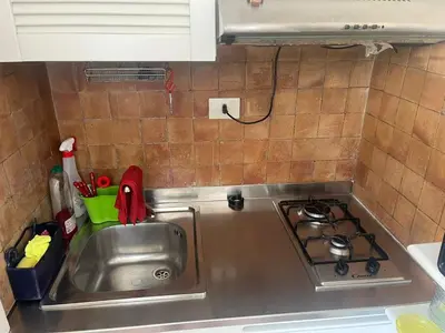 a kitchen counter with a sink and a stove at Casa Lella al Borgo Pio, a pochi passi da San Pietro in Rome