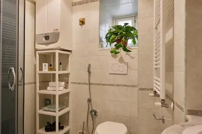 a bathroom with a shower and a toilet in it at TrastevereHome - Elegant Home Near Navona Square in Rome