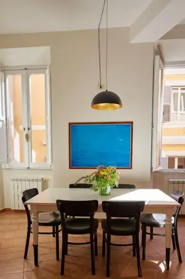 a dining room with a table and chairs at TrastevereHome - Elegant Home Near Navona Square in Rome