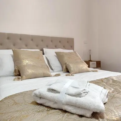 a bedroom with two beds with towels on them at Vatican Eco Suite in Rome
