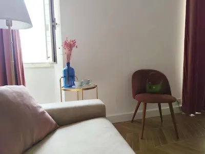 a living room with a couch and a chair at Vatican Eco Suite in Rome