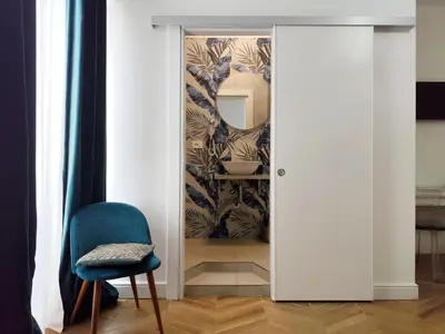a door leading into a room with a mirror at Vatican Eco Suite in Rome