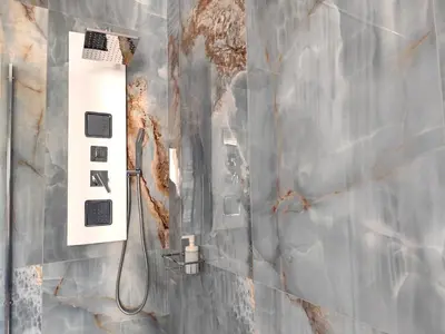 a bathroom with a shower with a wall at Vatican Eco Suite in Rome