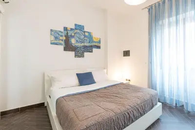 a bedroom with a bed and a painting on the wall at 5 Minutes to St Peter - Luxury Stay in Rome