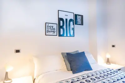 a bedroom with a bed with three pictures on the wall at 5 Minutes to St Peter - Luxury Stay in Rome