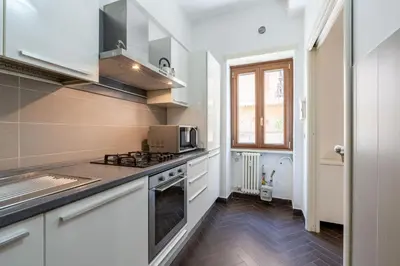 a kitchen with a stove and a microwave at 5 Minutes to St Peter - Luxury Stay in Rome