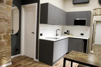 a kitchen with a sink and a table at Unique Trastevere in Rome