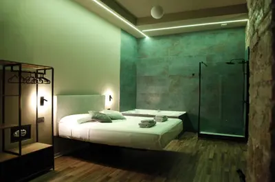 a bedroom with a bed and a glass shower at Unique Trastevere in Rome